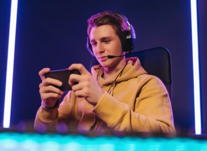 Pro cyber sportsman playing in mobile video game at home