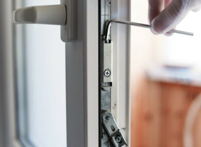 The man makes the adjustment of the pvc door mechanism with an allen key.